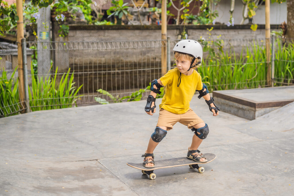Athletic,Boy,In,Helmet,And,Knee,Pads,Learns,To,Skateboard