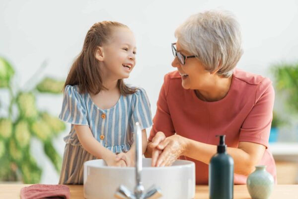 A,Cute,Little,Girl,And,Her,Grandmother,Are,Washing,Their